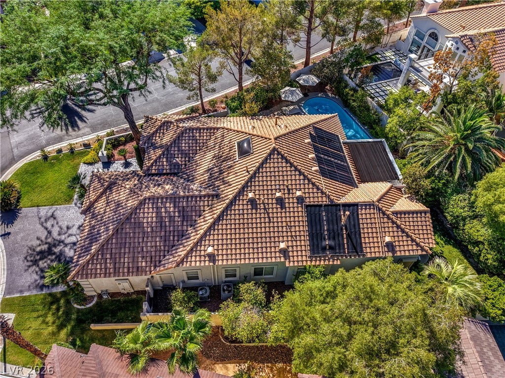 An aerial perspective showcases the distinctive tile roof and solar panels of this elegant home.