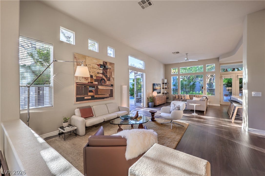 High ceilings and rich hardwood flooring define this open living area.