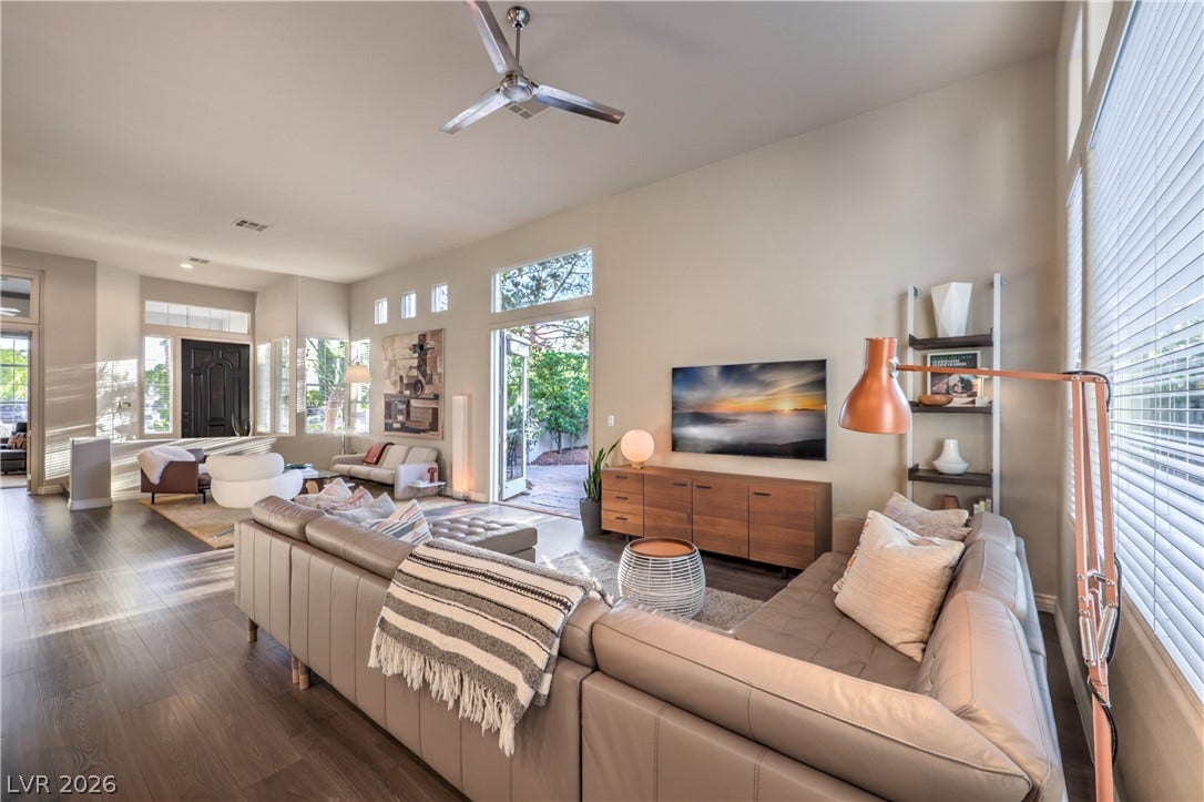 Gleaming wood floors and towering ceilings define this airy, open-concept living space.