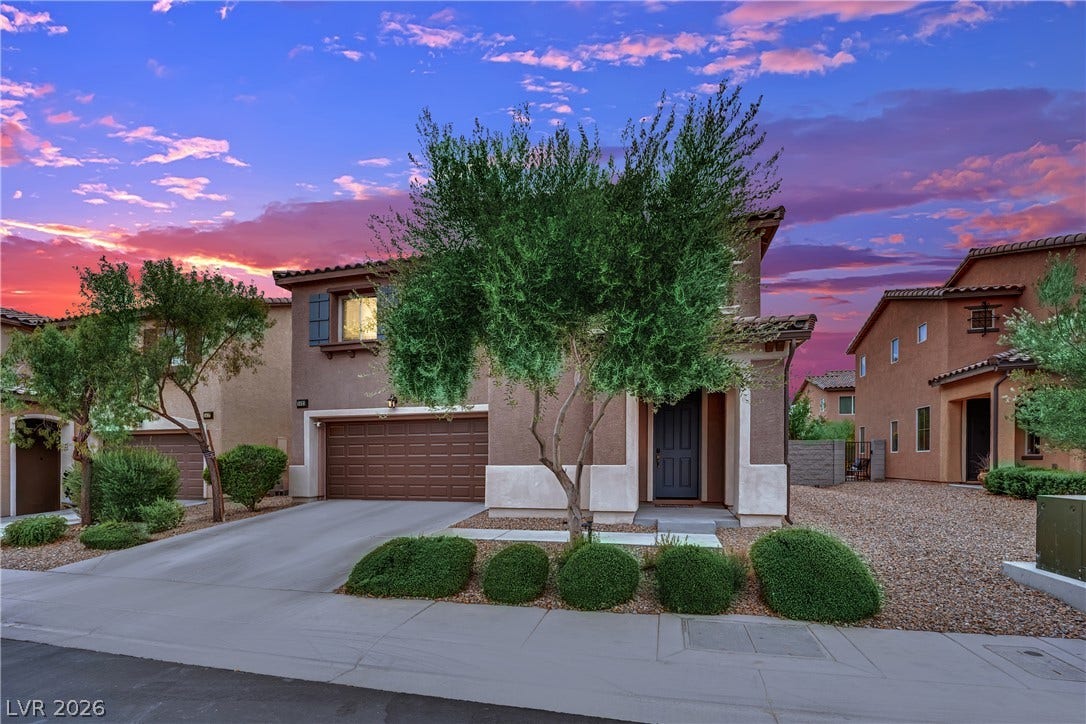 1421 Lamance Court, North Las Vegas, NV 89031 A classic stucco exterior features a tile roof, paved driveway, and neat desert landscaping.