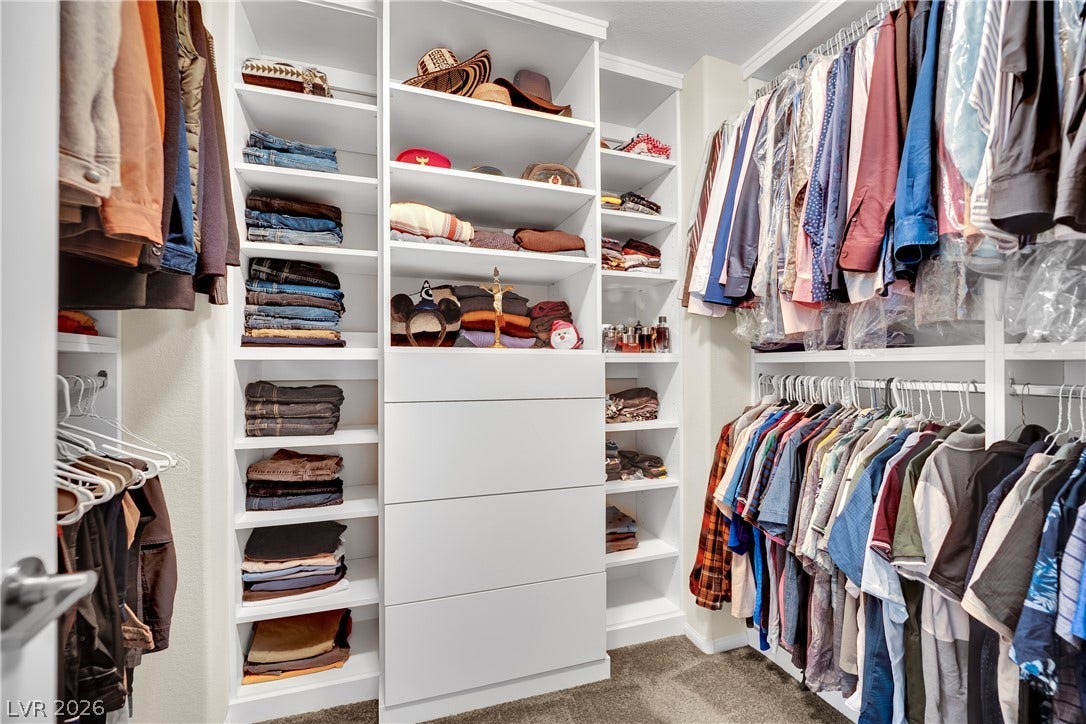 1421 Lamance Court, North Las Vegas, NV 89031 Custom built-in shelving and ample hanging space define this spacious walk-in closet.