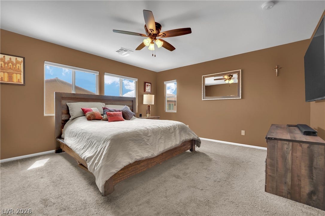 1421 Lamance Court, North Las Vegas, NV 89031 Plentiful windows fill this bedroom with natural light highlighting the soft carpet underfoot.