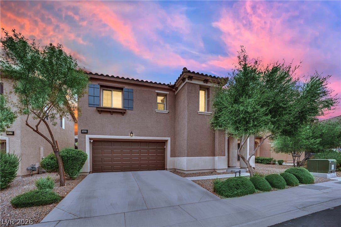 1421 Lamance Court, North Las Vegas, NV 89031 Elegant two-story exterior showcases a stucco facade and tile roof against a vibrant sunset sky.