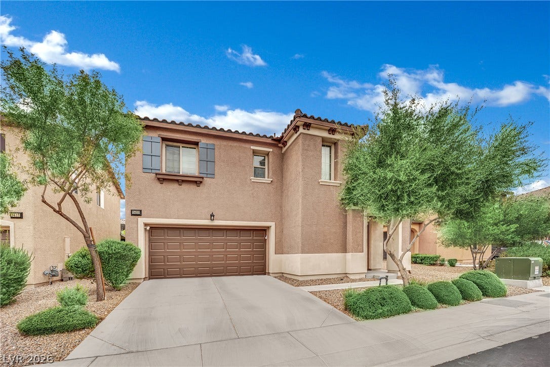 1421 Lamance Court, North Las Vegas, NV 89031 Stucco exterior and tiled roofline define this modern two-story home with integrated two-car garage.