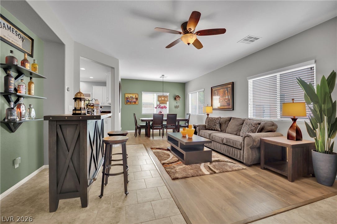 1421 Lamance Court, North Las Vegas, NV 89031 An open floorplan seamlessly connects the living space, dining area, and wet bar.