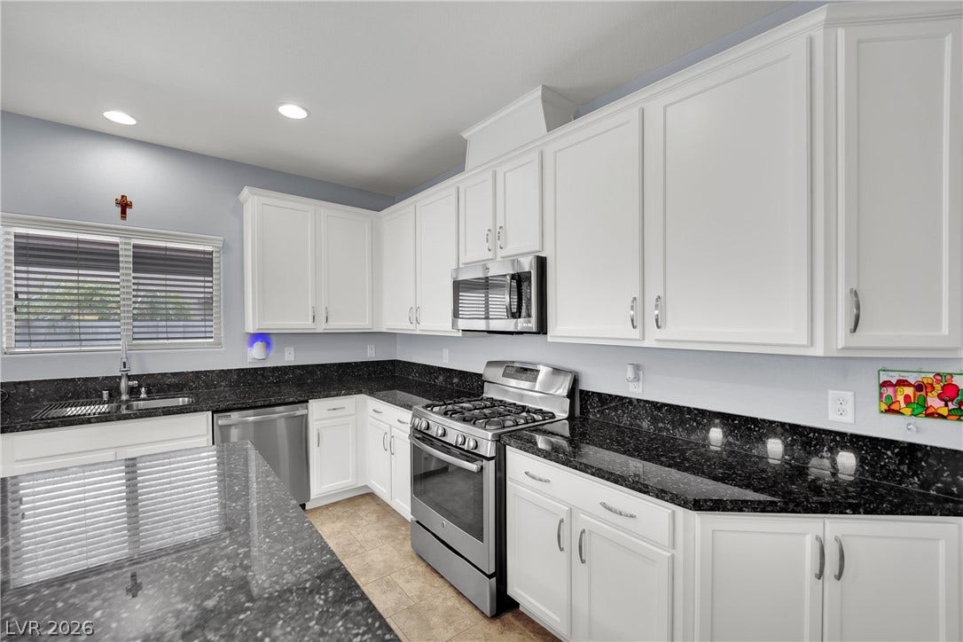 1421 Lamance Court, North Las Vegas, NV 89031 Gleaming stone countertops anchor this classic kitchen design with abundant cabinetry.
