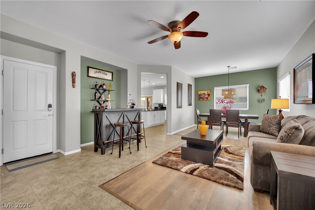 1421 Lamance Court, North Las Vegas, NV 89031 An open floorplan connects the living area, custom bar, and adjacent dining room.