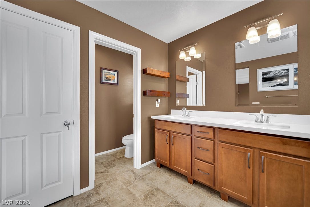 1421 Lamance Court, North Las Vegas, NV 89031 Ample counter space and dual vanities anchor this spacious bathroom layout.