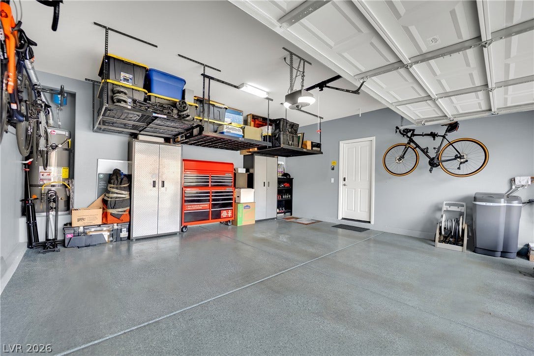 1421 Lamance Court, North Las Vegas, NV 89031 A spacious garage features durable finished concrete flooring and overhead storage racks.