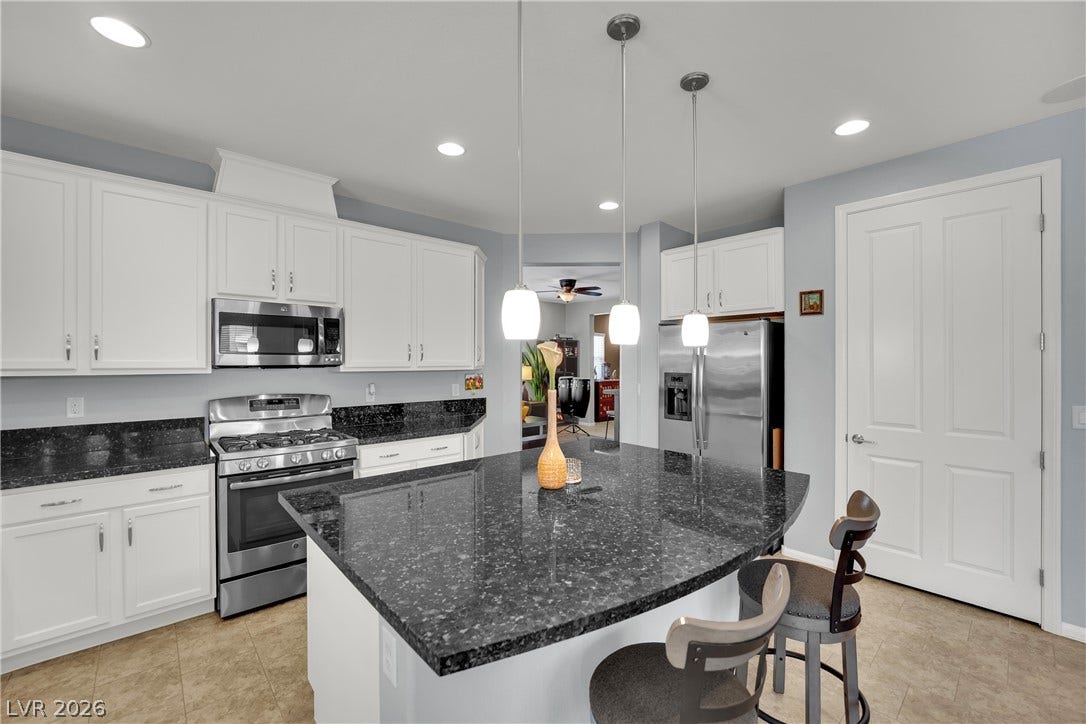 1421 Lamance Court, North Las Vegas, NV 89031 Polished granite countertops and classic cabinetry anchor this functional cooking space.