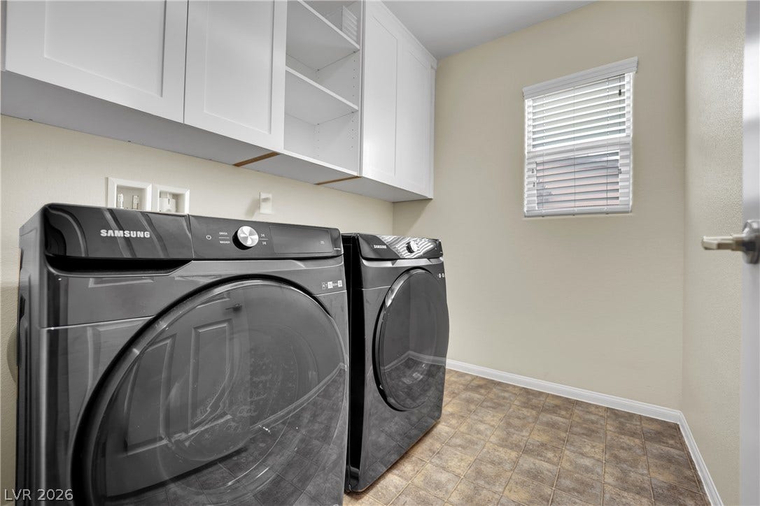 1421 Lamance Court, North Las Vegas, NV 89031 A functional laundry space highlights upper cabinetry storage and durable tile flooring.