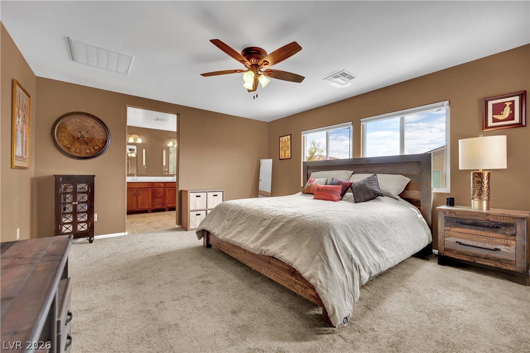 1421 Lamance Court, North Las Vegas, NV 89031 Plentiful natural light streams across this spacious bedroom offering an attached bath.