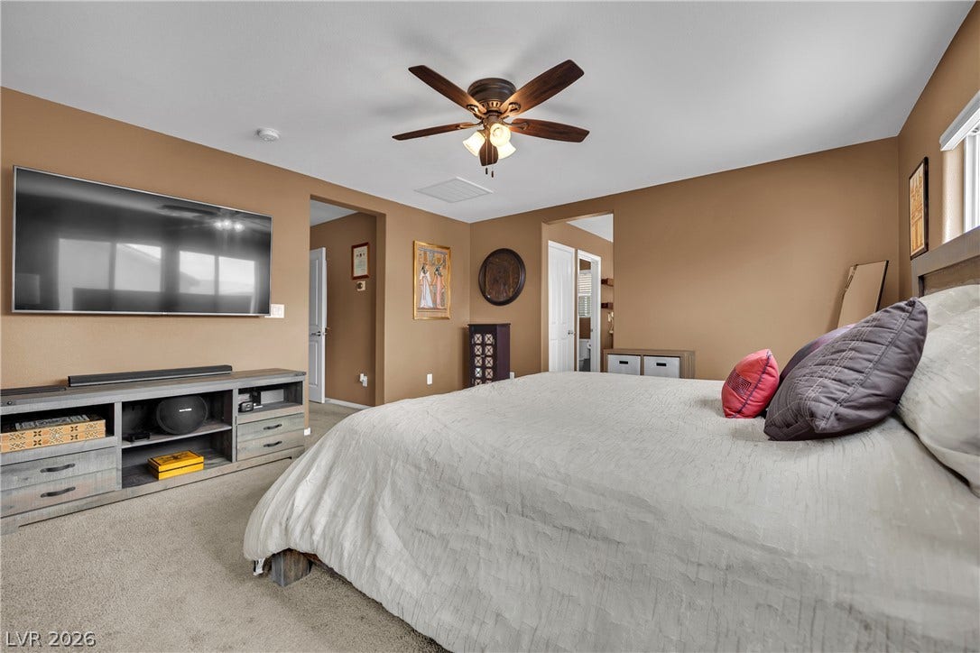1421 Lamance Court, North Las Vegas, NV 89031 Warm earth tones and soft carpeting create a cozy, inviting atmosphere in this bedroom.
