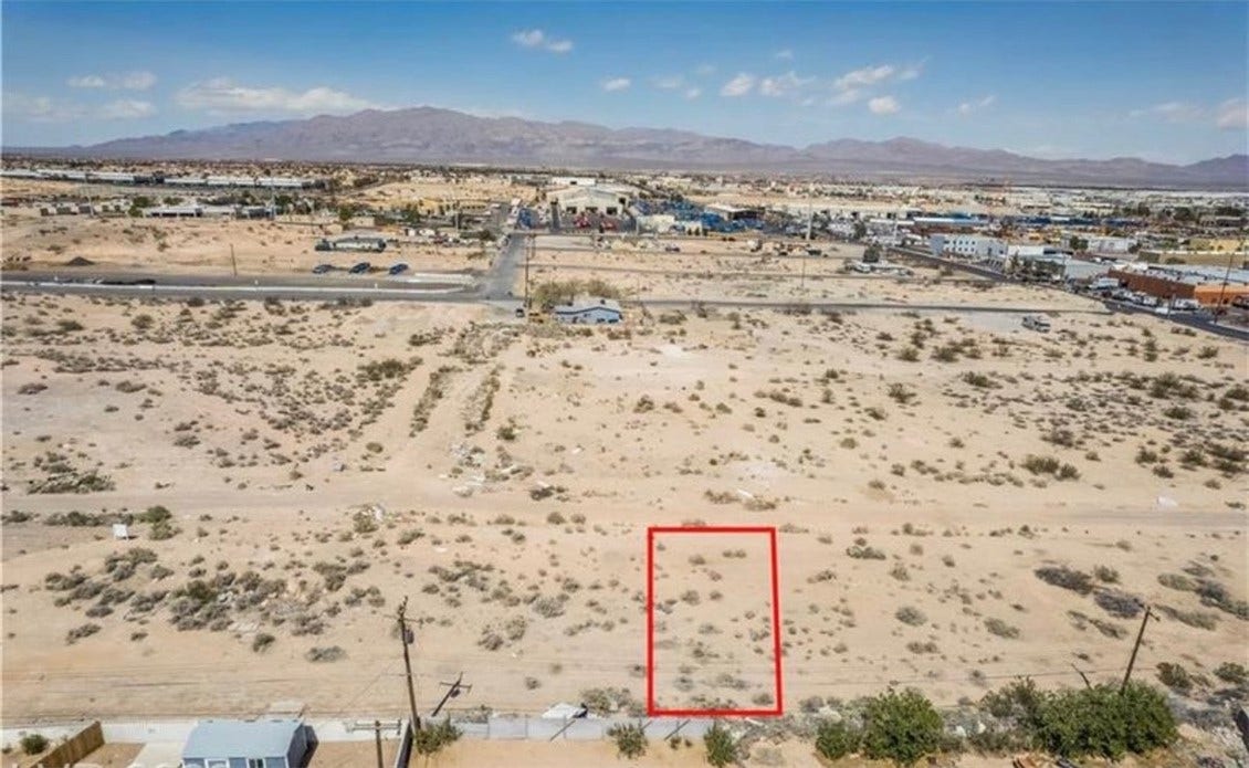 Commerce And Windsor, North Las Vegas, NV 89030 An aerial view showcases a vacant desert parcel set against a distant mountain backdrop.