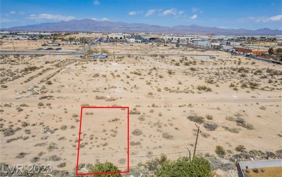 An aerial view highlights the property boundaries against a backdrop of sweeping desert mountains.