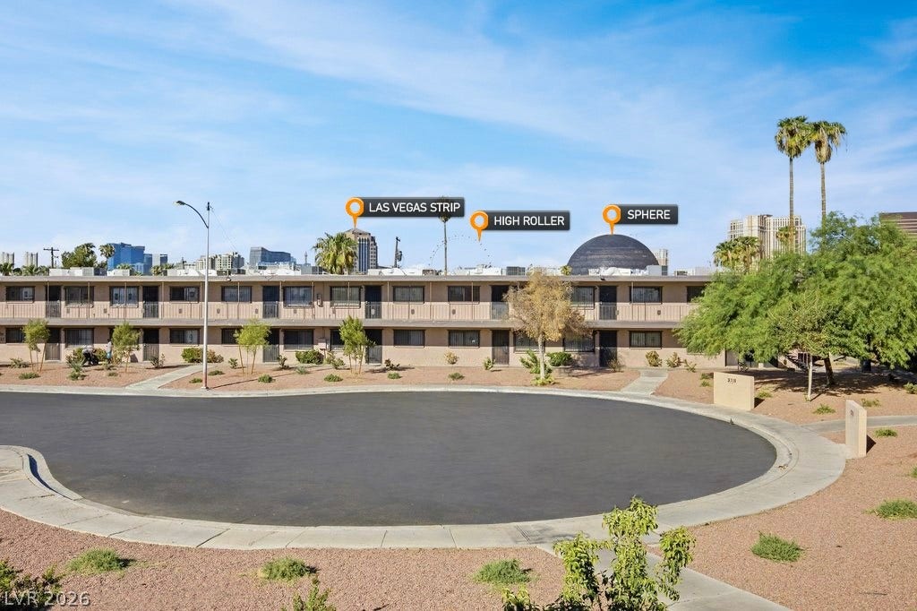 3726 Hazelwood Street, #14, Las Vegas, NV 89119 Iconic city landmarks frame the horizon above this multi-level residential structure.
