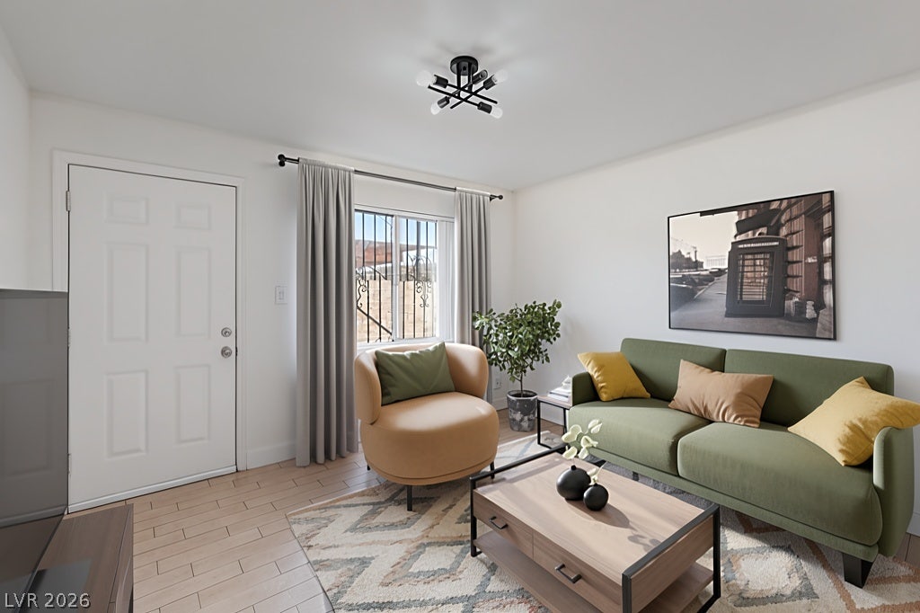 3726 Hazelwood Street, #14, Las Vegas, NV 89119 *Virtually Staged* Natural light from a front window anchor this welcoming entryway living space with room for a sofa, chair, coffee table, and a TV entertainment stand