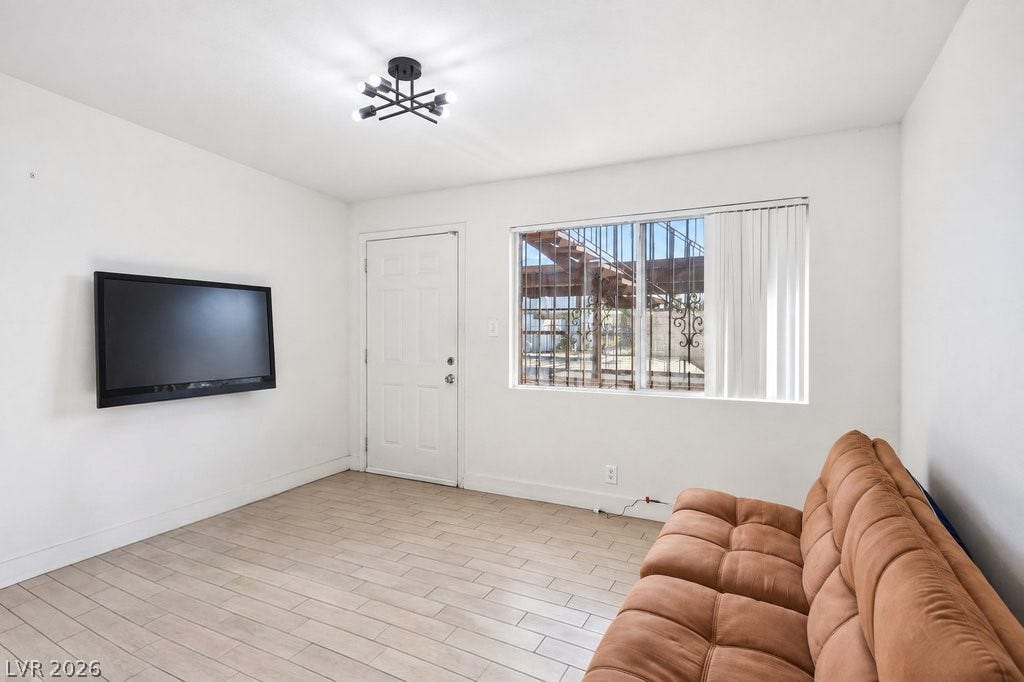 3726 Hazelwood Street, #14, Las Vegas, NV 89119 Durable ceramic tile flooring and a neutral color palette anchor this versatile, sunlit living area.