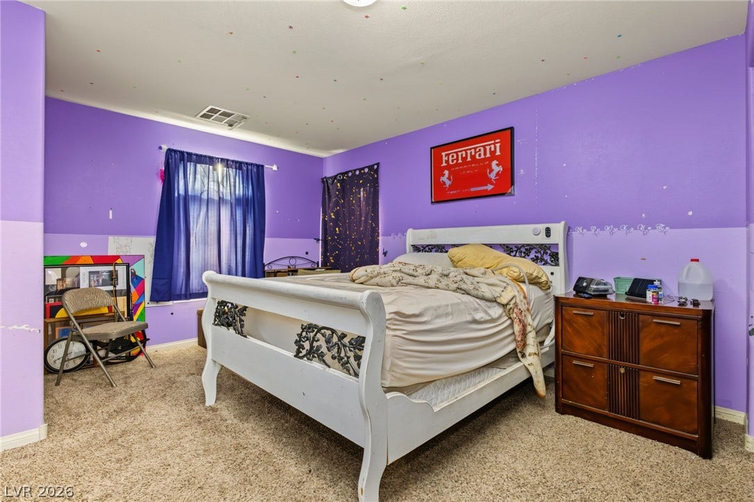 7021 Albatross Attic Street, North Las Vegas, NV 89084 Plush carpeting and wide windows define this versatile secondary bedroom space.
