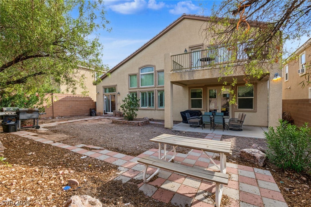 7021 Albatross Attic Street, North Las Vegas, NV 89084 An inviting rear patio and balcony overlook the spacious yard of this two-story home.