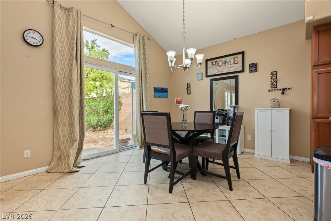 7021 Albatross Attic Street, North Las Vegas, NV 89084 Vaulted ceilings and tile flooring enhance this dining area opening to the backyard.