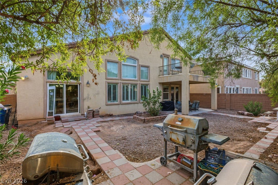 7021 Albatross Attic Street, North Las Vegas, NV 89084 Mature trees frame the stucco exterior of this multi-level home featuring a private balcony.