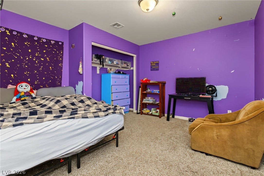 7021 Albatross Attic Street, North Las Vegas, NV 89084 Carpeted flooring completes this secondary bedroom with a built-in closet recess.