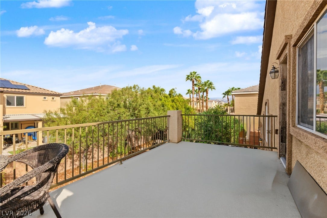7021 Albatross Attic Street, North Las Vegas, NV 89084 An elevated private balcony overlooks manicured surrounding trees and neighborhood views under sunny skies.