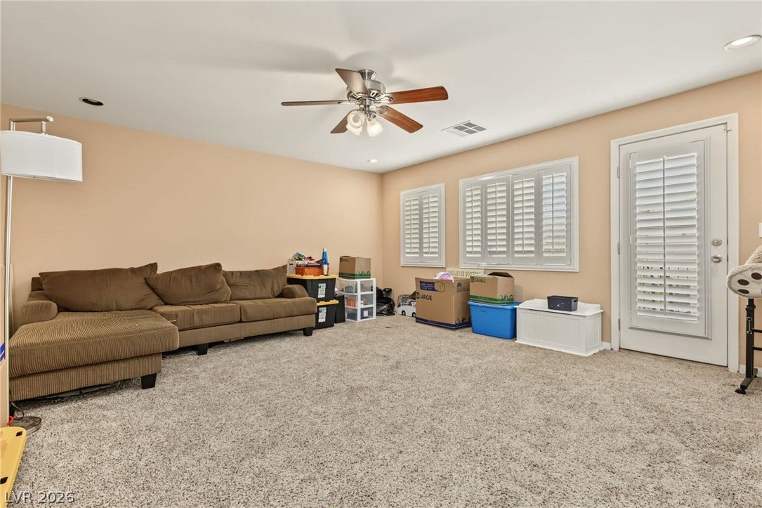 7021 Albatross Attic Street, North Las Vegas, NV 89084 Plush wall-to-wall carpeting and plantation shutters highlight this versatile living space.