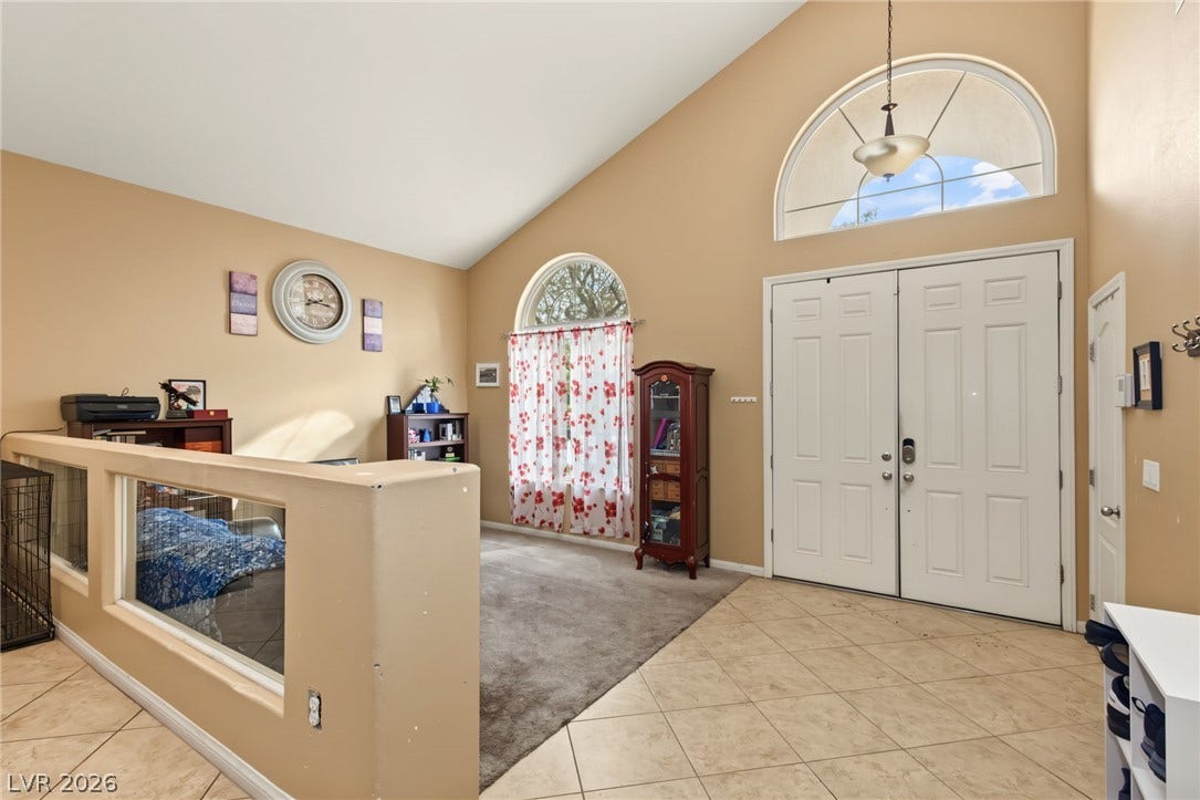 7021 Albatross Attic Street, North Las Vegas, NV 89084 Soaring ceilings and arched windows create an airy entry welcoming you inside.
