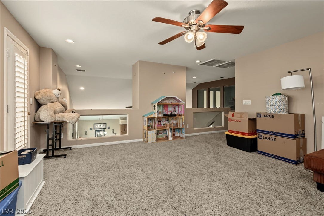 7021 Albatross Attic Street, North Las Vegas, NV 89084 An open loft space features wall-to-wall carpeting and views to the lower level.