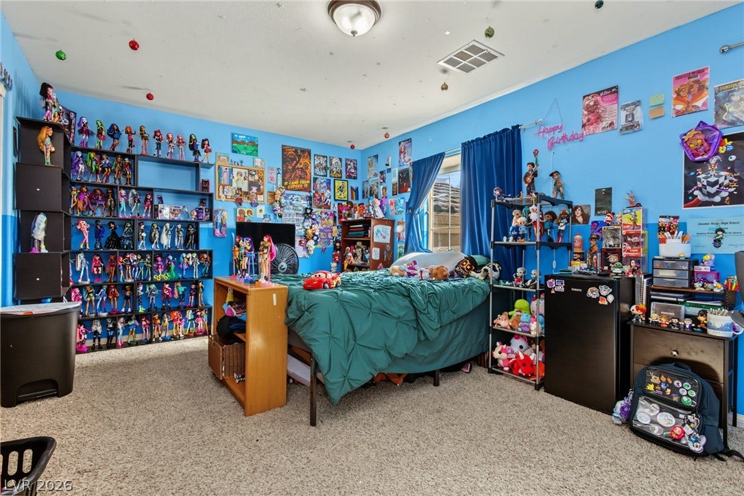7021 Albatross Attic Street, North Las Vegas, NV 89084 An abundance of natural light fills this cozy secondary bedroom through a side window.