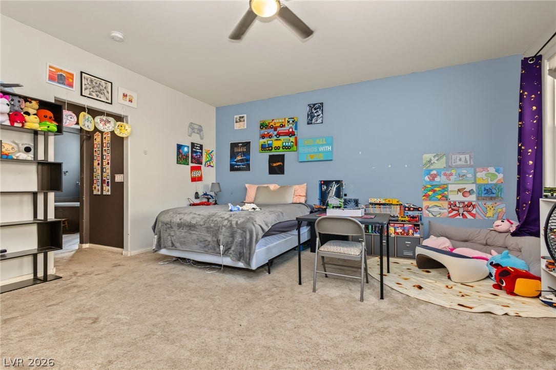 7021 Albatross Attic Street, North Las Vegas, NV 89084 A spacious secondary bedroom features plush wall-to-wall carpeting and natural light.