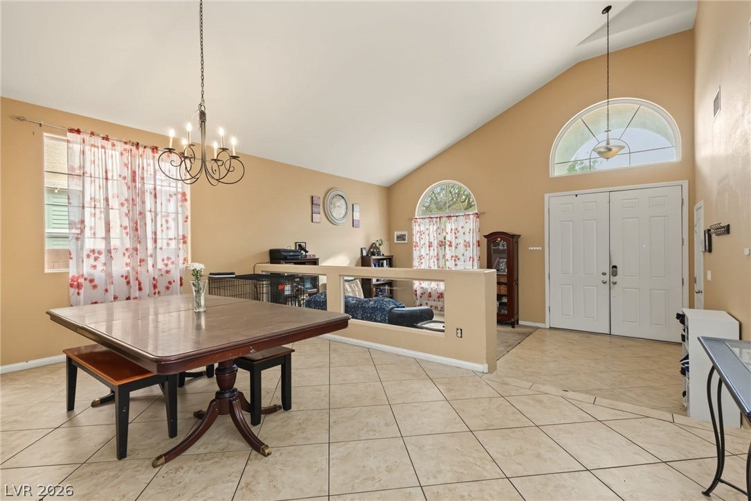 7021 Albatross Attic Street, North Las Vegas, NV 89084 Vaulted ceilings soar over the tiled entry foyer and open dining area.