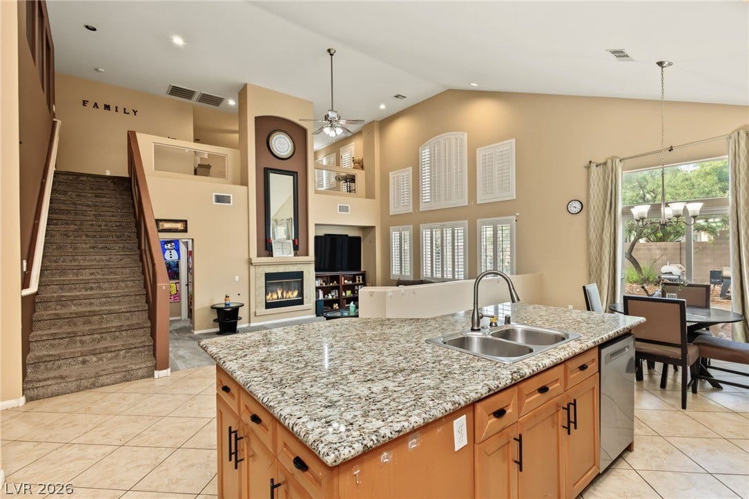 7021 Albatross Attic Street, North Las Vegas, NV 89084 An open kitchen overlooks a spacious living area with soaring ceilings and tile floors.