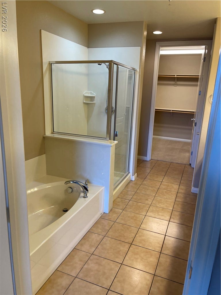 32 E Serene Avenue, #407, Las Vegas, NV 89123 A spacious layout incorporates a glass-enclosed shower alongside a deep soaking tub.