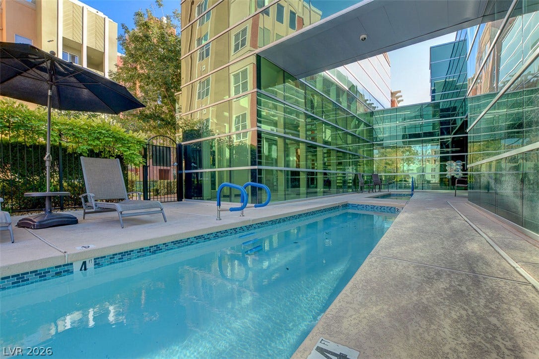 32 E Serene Avenue, #407, Las Vegas, NV 89123 A lap pool sits nestled alongside sleek contemporary glass architecture.