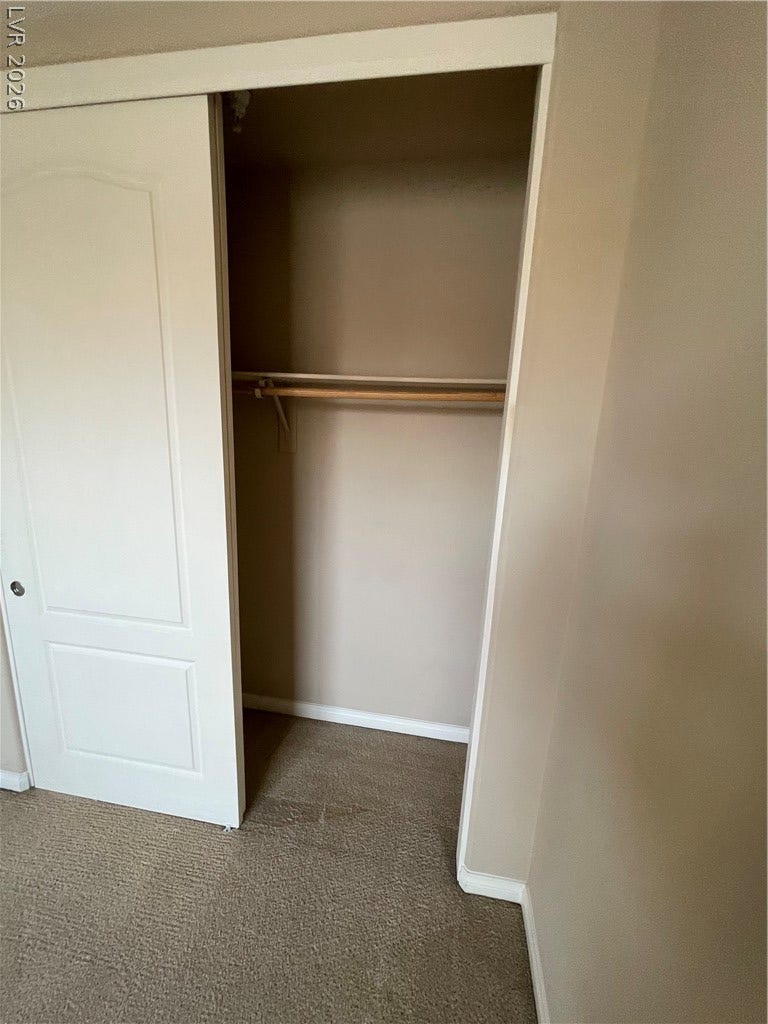 32 E Serene Avenue, #407, Las Vegas, NV 89123 A sliding door opens to reveal a built-in closet with carpeted flooring.
