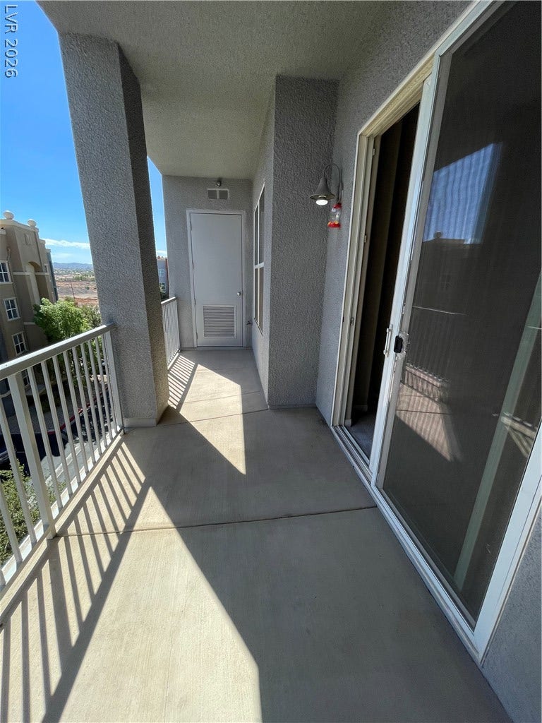 32 E Serene Avenue, #407, Las Vegas, NV 89123 A private covered balcony features durable concrete flooring and a sliding glass entry door.