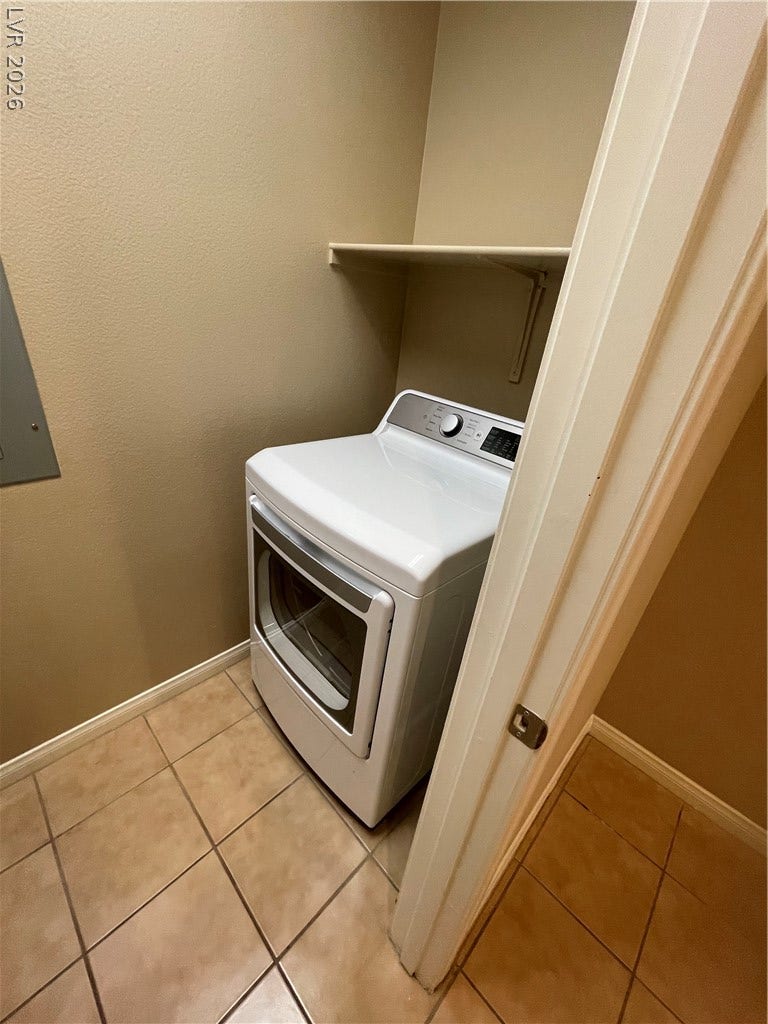32 E Serene Avenue, #407, Las Vegas, NV 89123 Tiled flooring and built-in shelving maximize the utility of this dedicated laundry space.