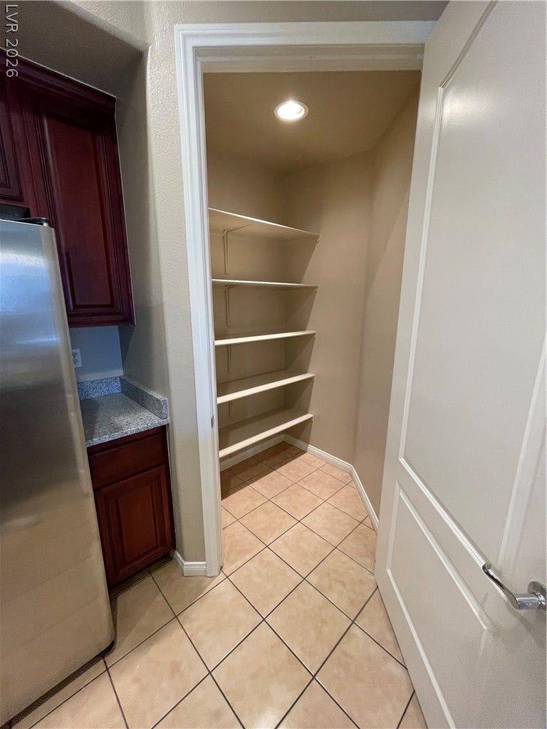 32 E Serene Avenue, #407, Las Vegas, NV 89123 Ample built-in shelving provides generous storage space directly off the tiled kitchen area.