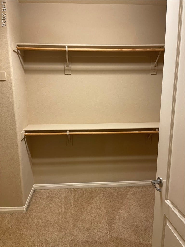32 E Serene Avenue, #407, Las Vegas, NV 89123 Ample storage options await in this practical built-in closet space with neutral carpeting.