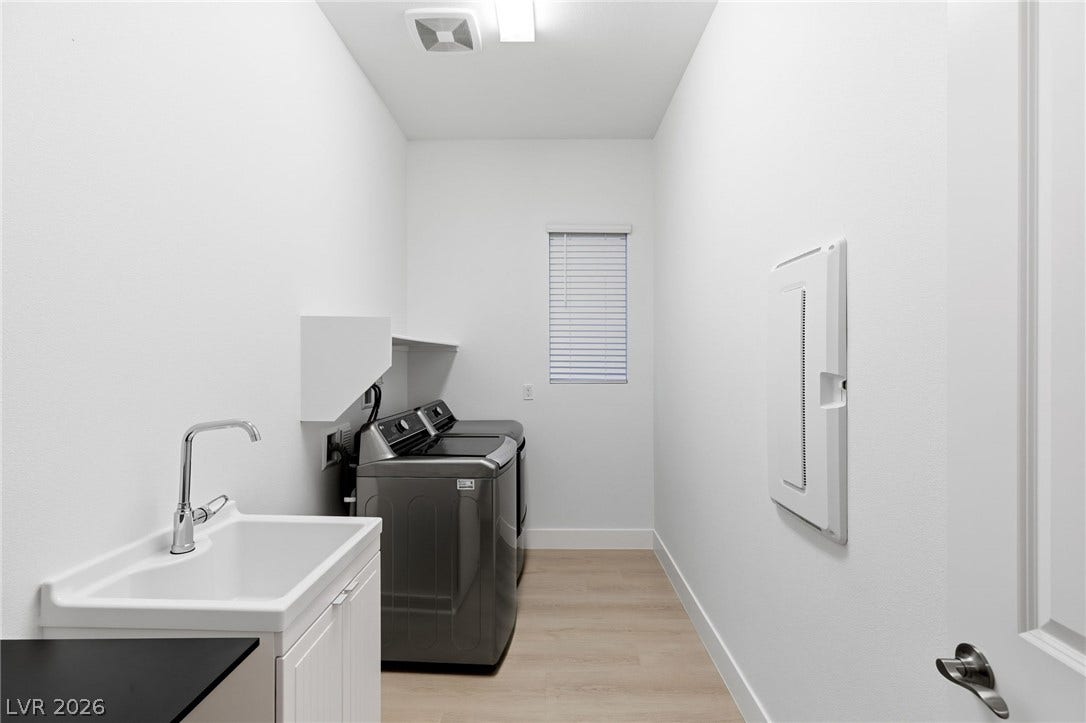 A well-equipped utility room provides practical functionality with a laundry sink and appliances.