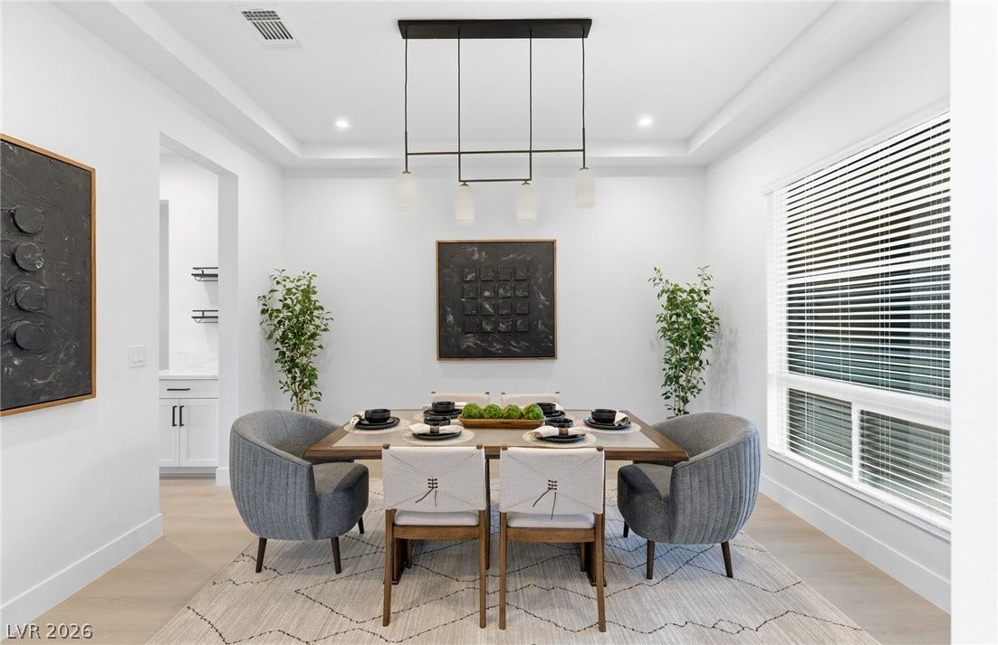 Clean lines and a striking pendant light define this well-appointed dining space.