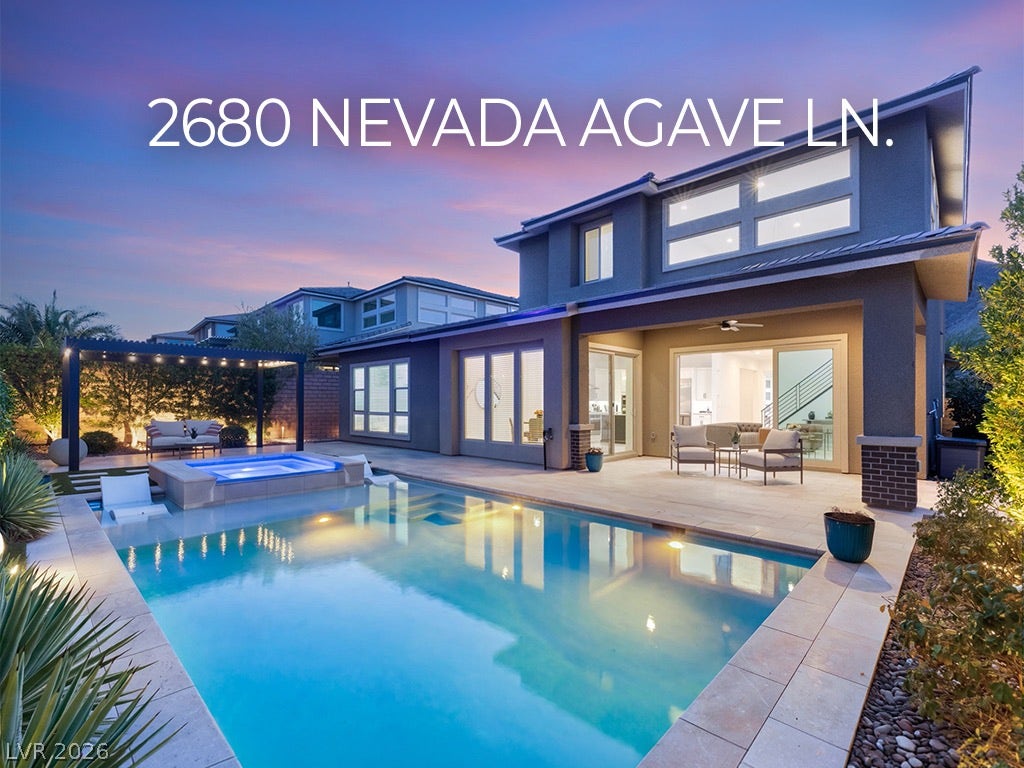 An inviting backyard oasis features a shimmering pool, integrated spa, and spacious patio for entertaining.