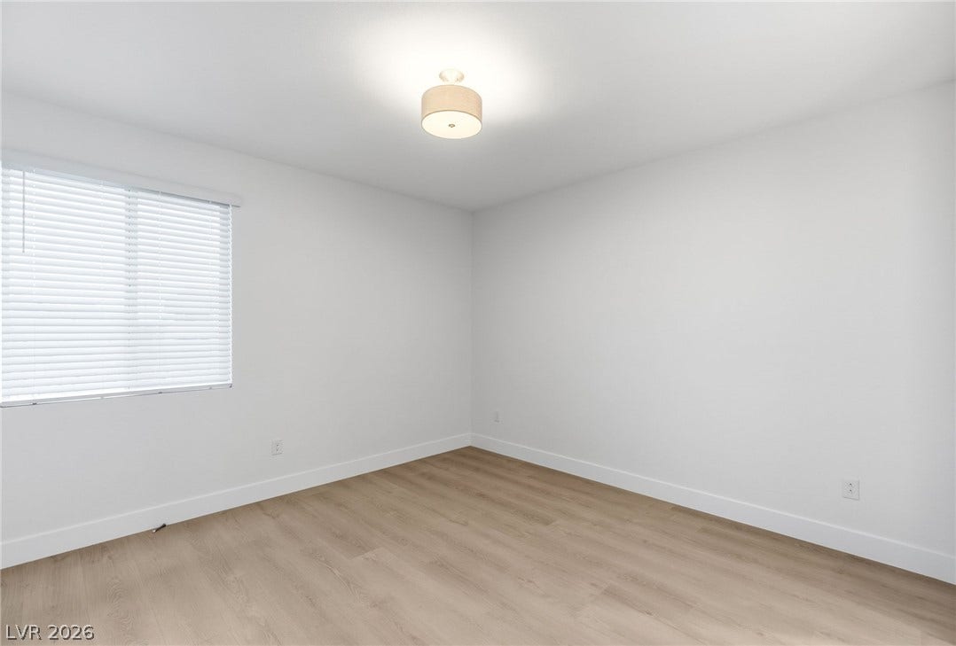 A well-proportioned room with durable flooring, ready for personalization.