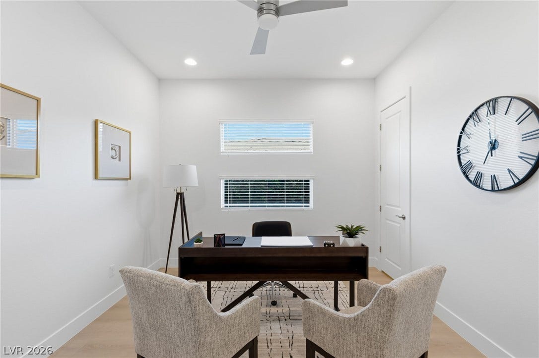 A well-lit study with a modern ceiling fan offers a peaceful work environment.