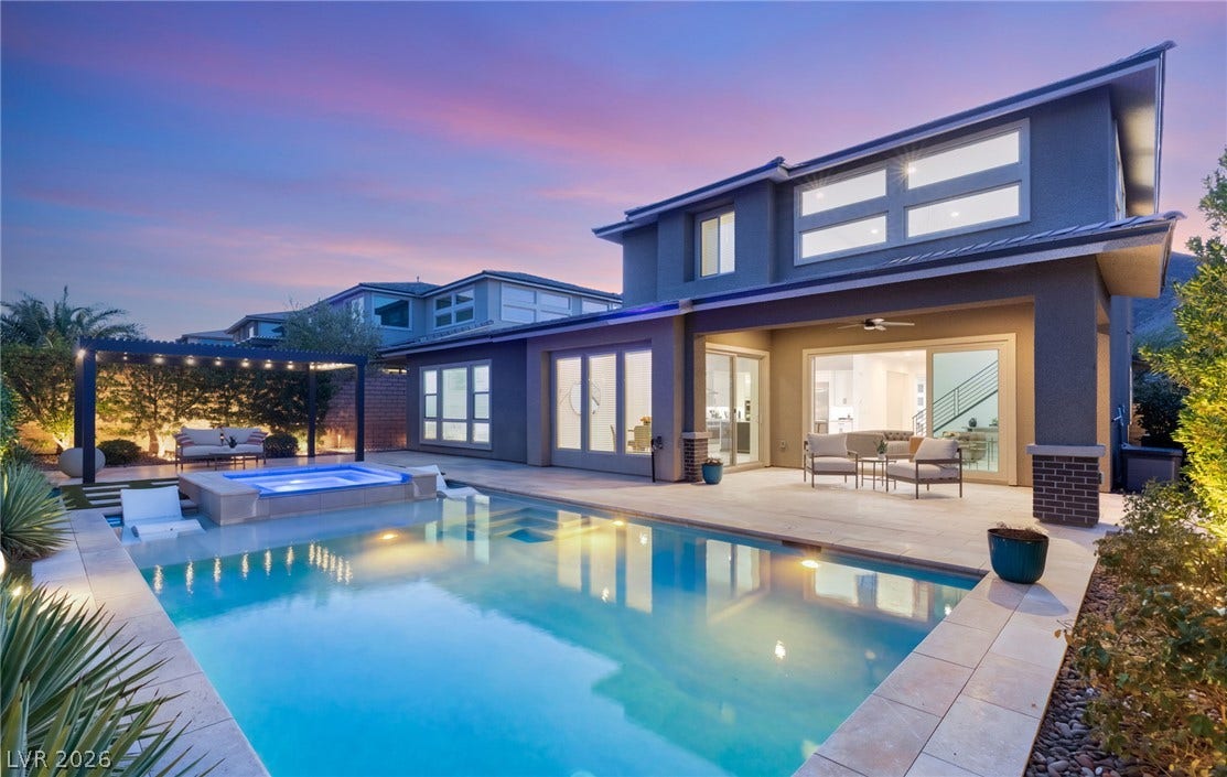An inviting backyard oasis offers a sparkling in-ground pool, elevated spa, and a spacious covered patio for outdoor enjoyment.