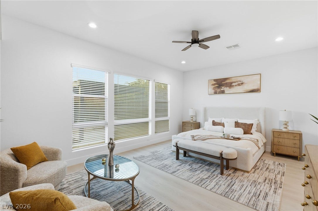 A tranquil primary suite offers ample natural light and serene living space.