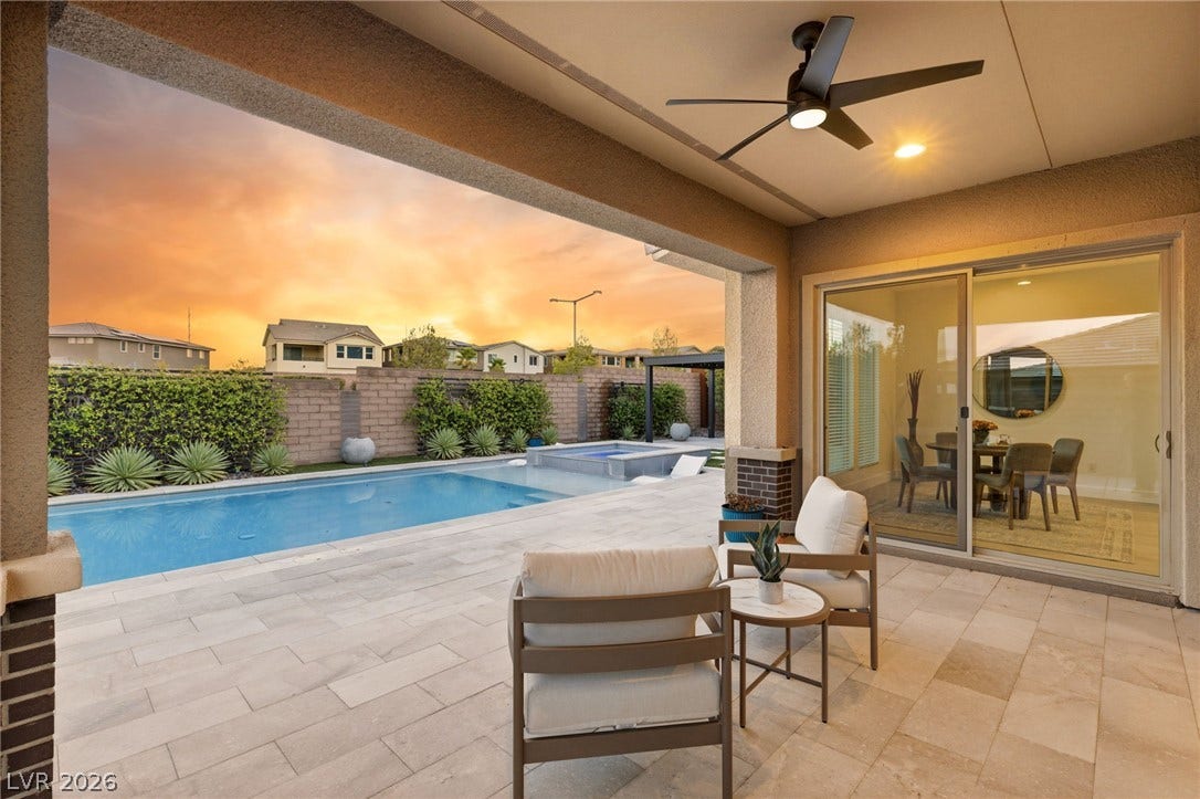 An inviting covered patio offers a refreshing pool and spa, perfect for enjoying sunset views.
